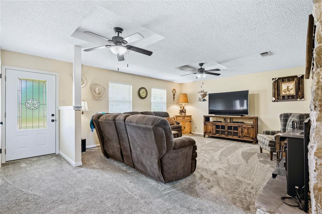 235 Magnus Road Denison, TX 75021 - Photo 14 of 35 a living room with furniture and a flat screen tv