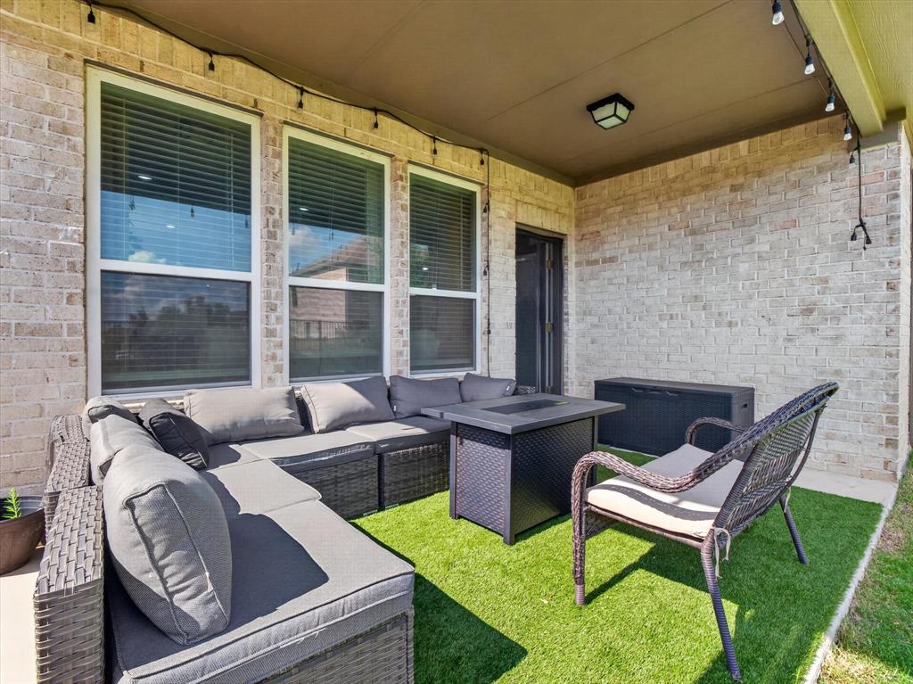 636 Corner Post Path Celina, TX 75009 - Photo 32 of 40 Covered patio featuring brick exterior walls and a turf-covered floor