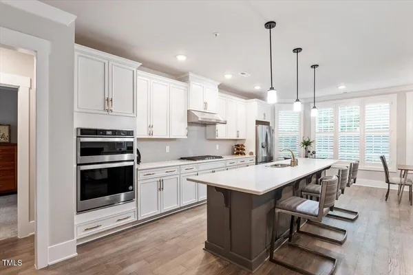 a kitchen with a stove a sink and a refrigerator