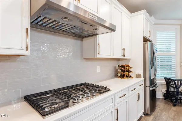 a stove top oven sitting inside of a kitchen
