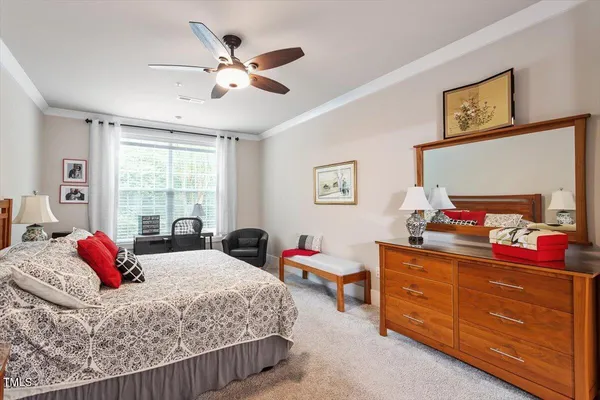 a bedroom with a bed dresser and a window