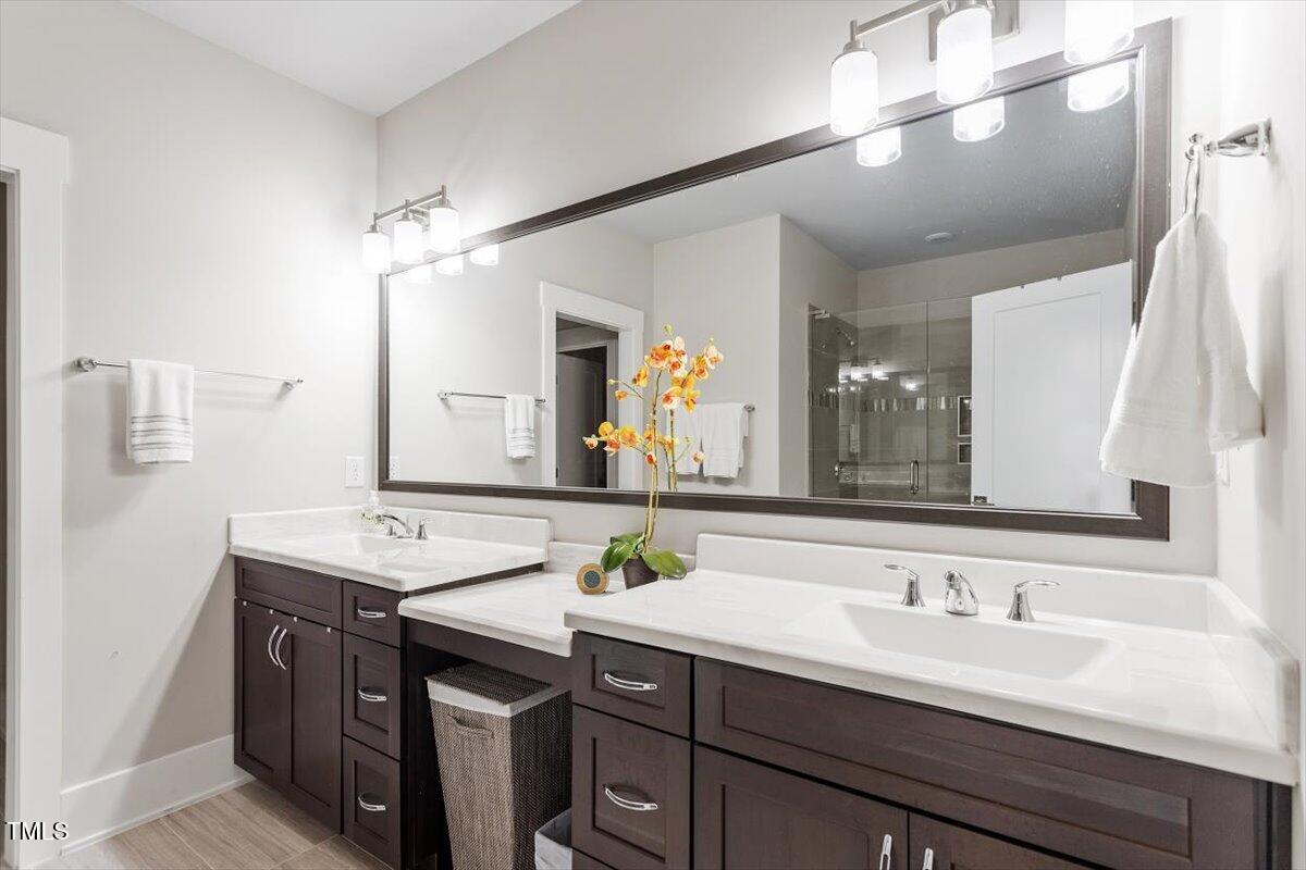10310 Sablewood Drive, Unit 115 Raleigh, NC 27617 - Photo 17 of 28 a bathroom with a sink and a mirror