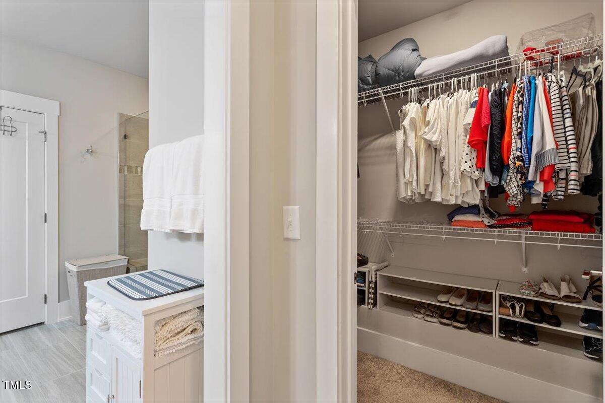 10310 Sablewood Drive, Unit 115 Raleigh, NC 27617 - Photo 19 of 28 a view of walk in closet with clothes and shoes