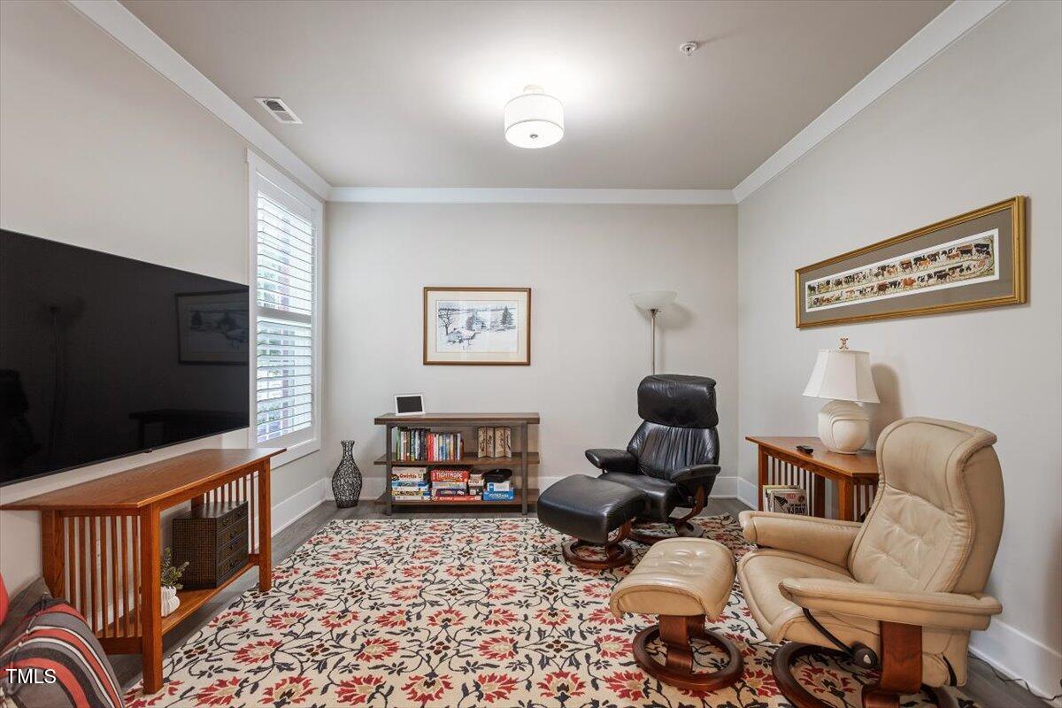 10310 Sablewood Drive, Unit 115 Raleigh, NC 27617 - Photo 21 of 28 a living room with furniture and a flat screen tv