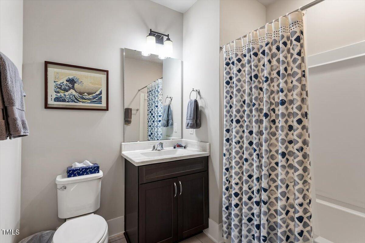 10310 Sablewood Drive, Unit 115 Raleigh, NC 27617 - Photo 22 of 28 a bathroom with a sink and a mirror