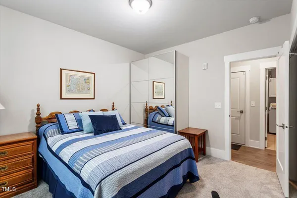 a bedroom with a bed and a mirror