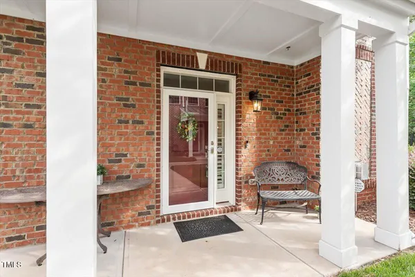 a front view of a house with outdoor seating and a potted plant