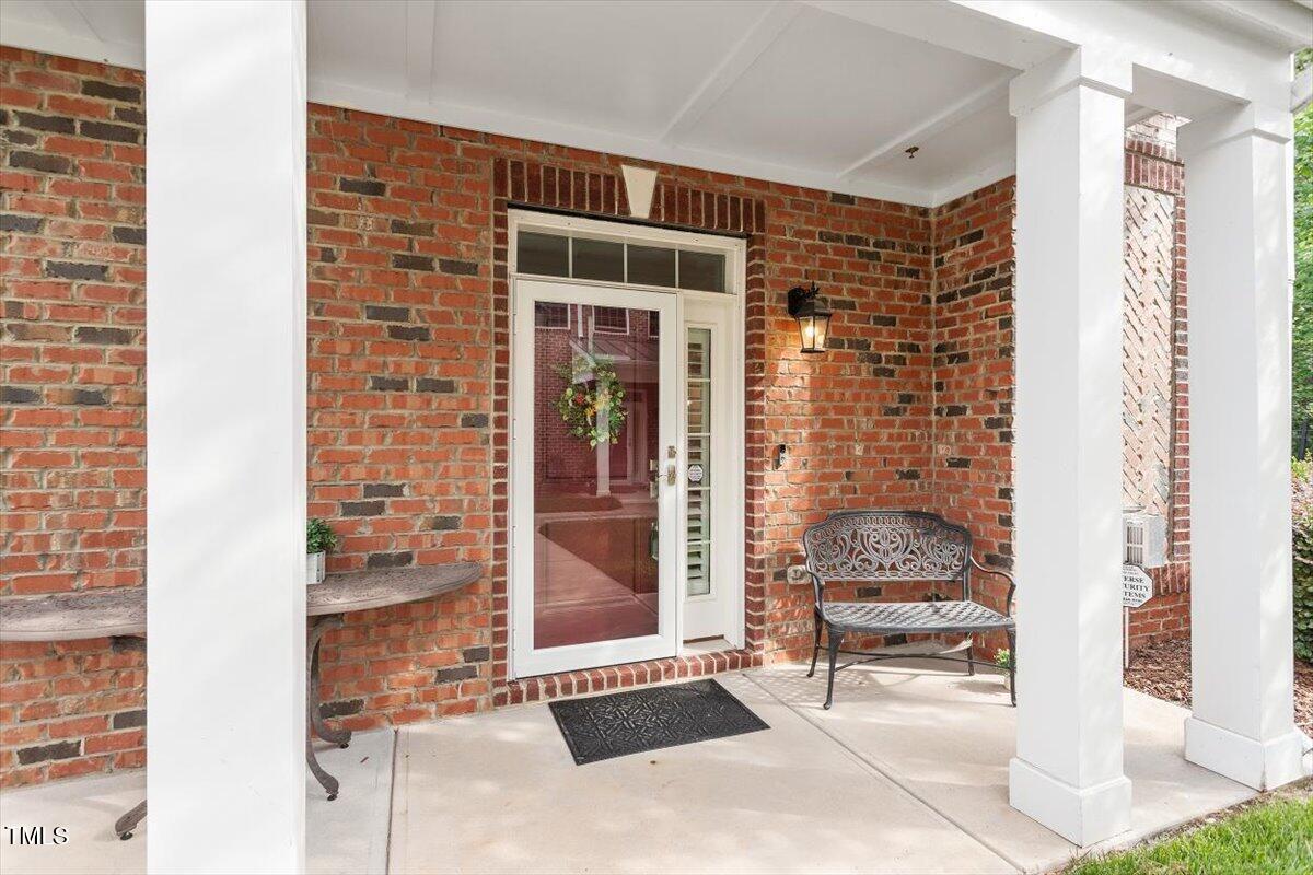 10310 Sablewood Drive, Unit 115 Raleigh, NC 27617 - Photo 3 of 28 a front view of a house with outdoor seating and a potted plant