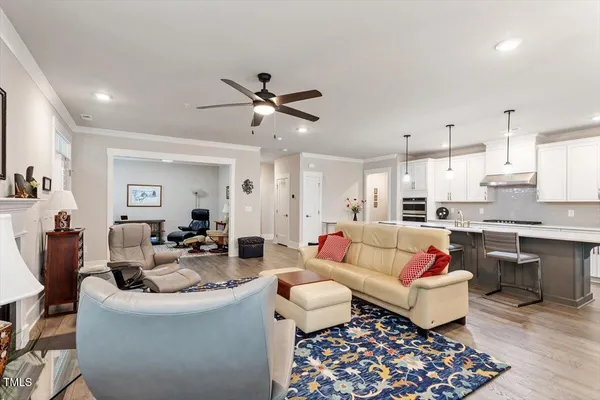 a living room with lots of furniture and kitchen view