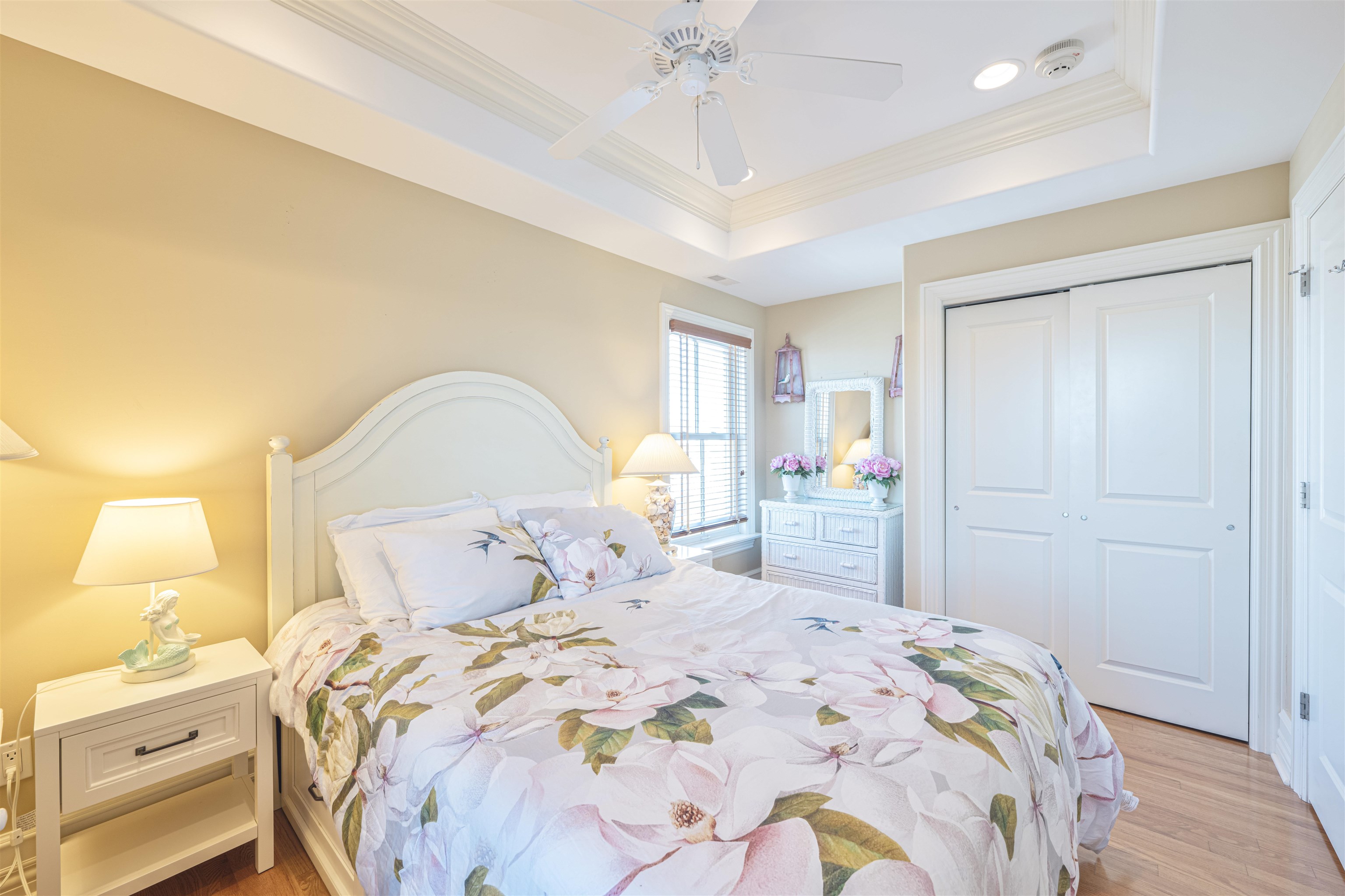 927 Beach, Unit 6 Cape May, NJ 08204 - Photo 24 of 34 a bedroom with a bed and a chandelier