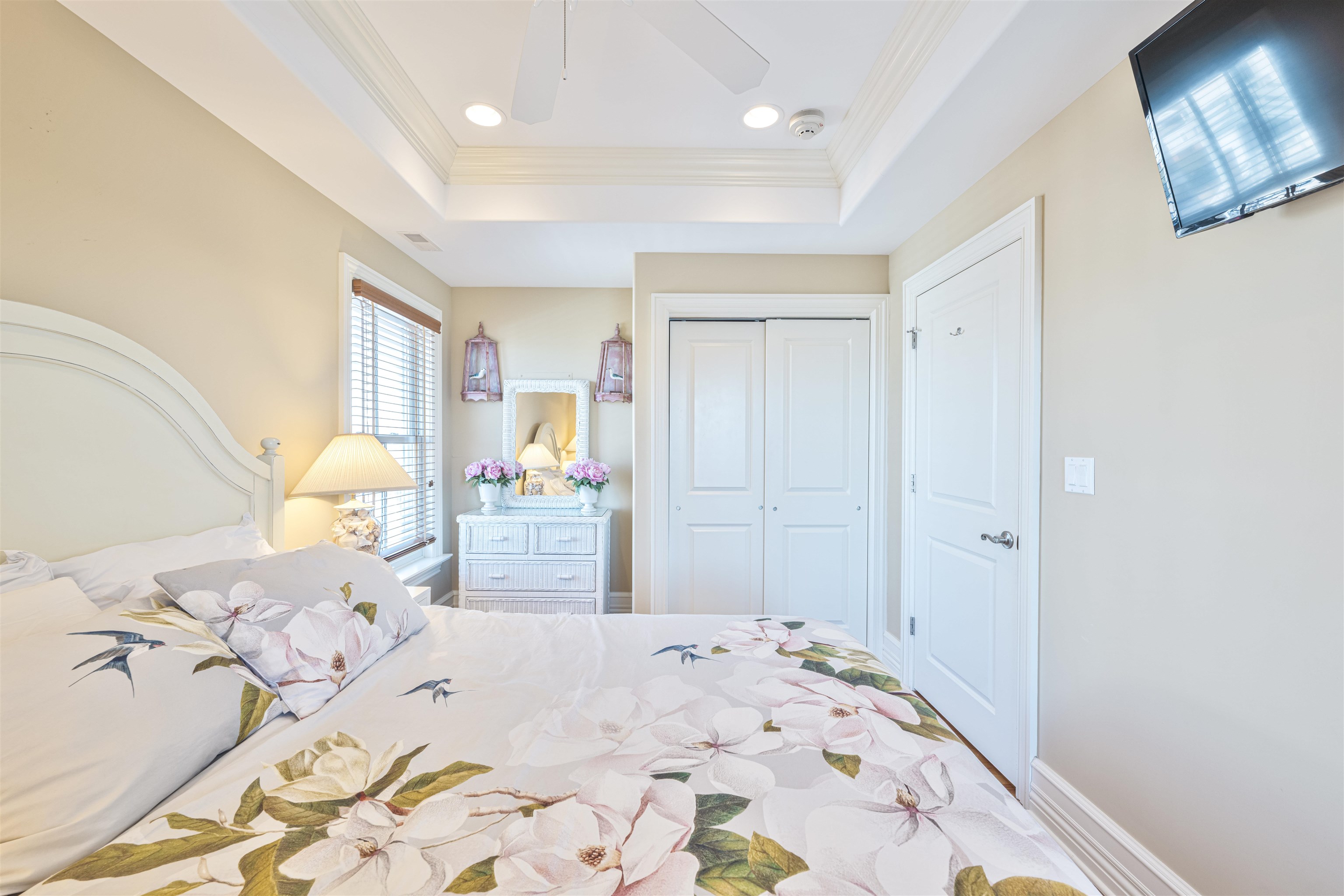 927 Beach, Unit 6 Cape May, NJ 08204 - Photo 25 of 34 a bedroom with a bed and a chandelier