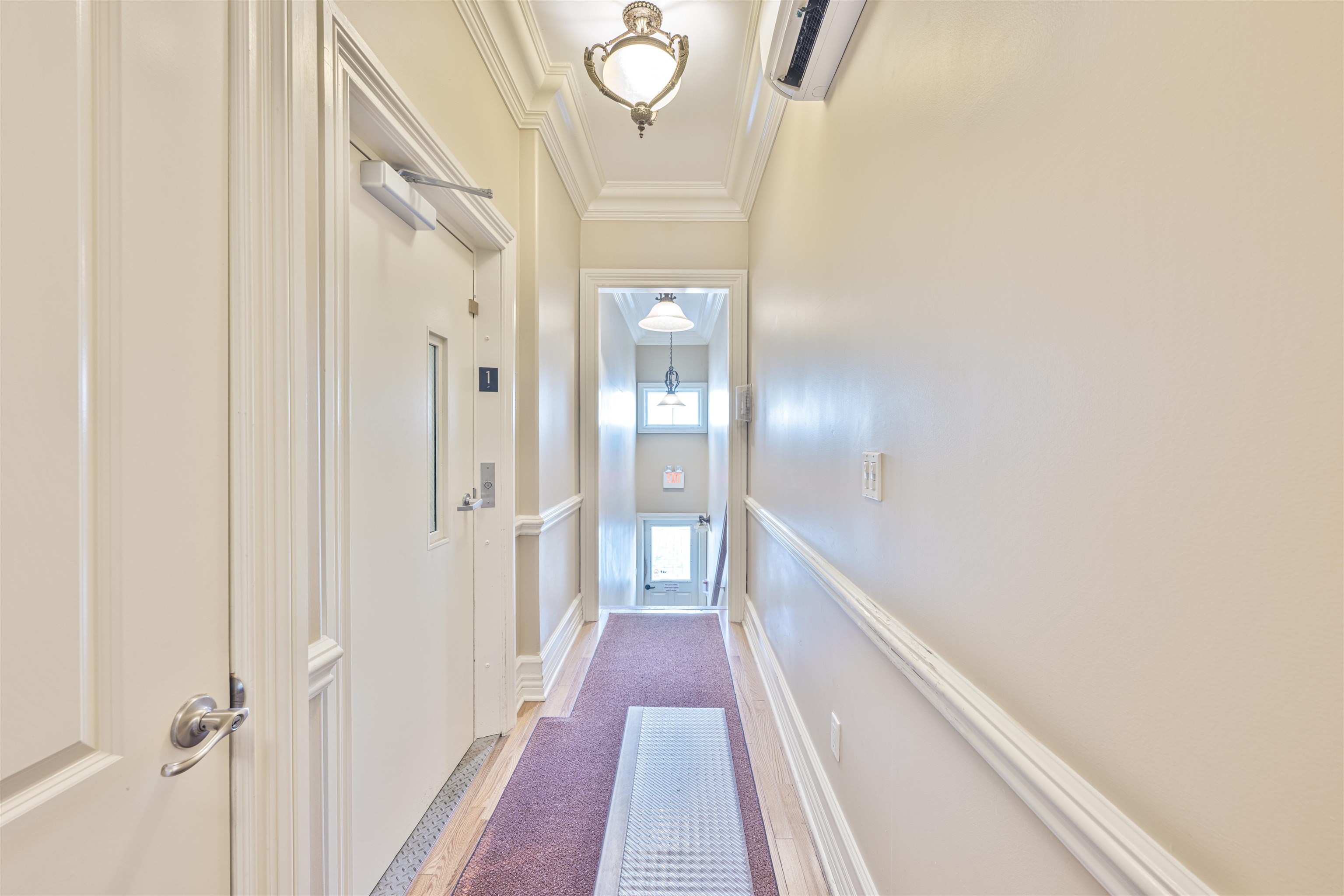 927 Beach, Unit 6 Cape May, NJ 08204 - Photo 26 of 34 a view of a hallway with wooden floor and staircase