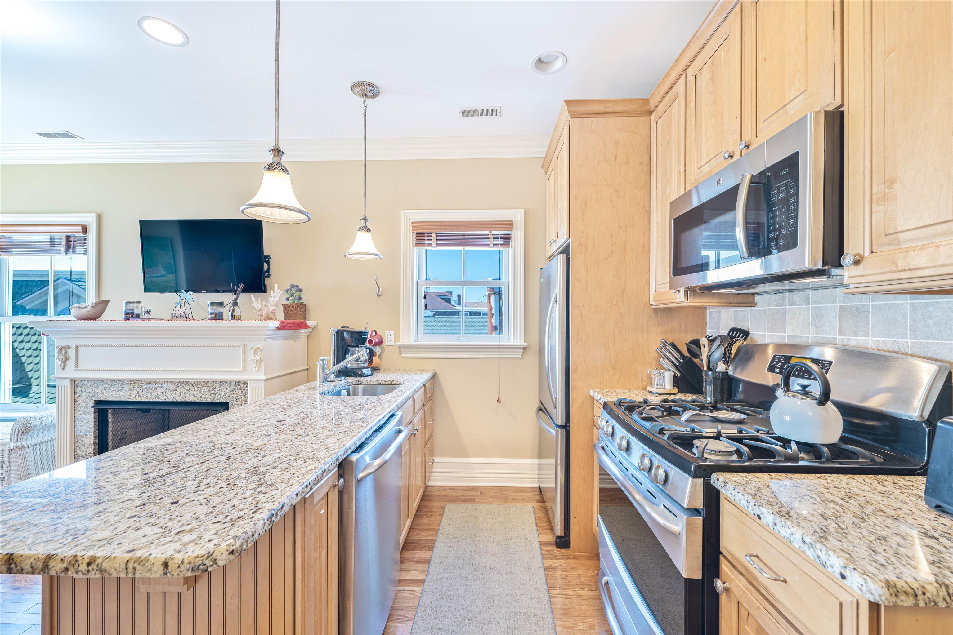 927 Beach, Unit 6 Cape May, NJ 08204 - Photo 6 of 34 a kitchen with stainless steel appliances granite countertop a stove and a sink