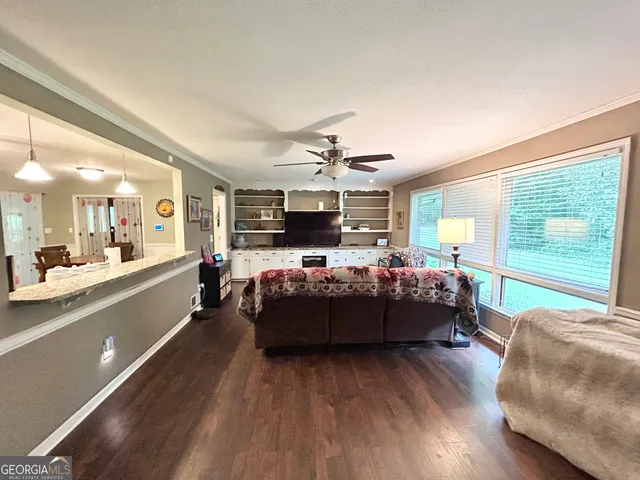 a spacious bedroom with a bed a couch and dresser