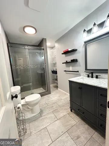 a bedroom with a bed with furniture and mirror