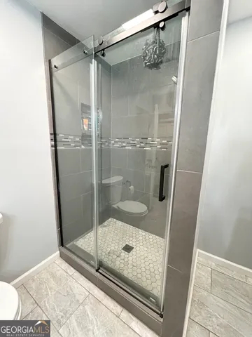 a view of a livingroom with furniture an umbrella and workspace