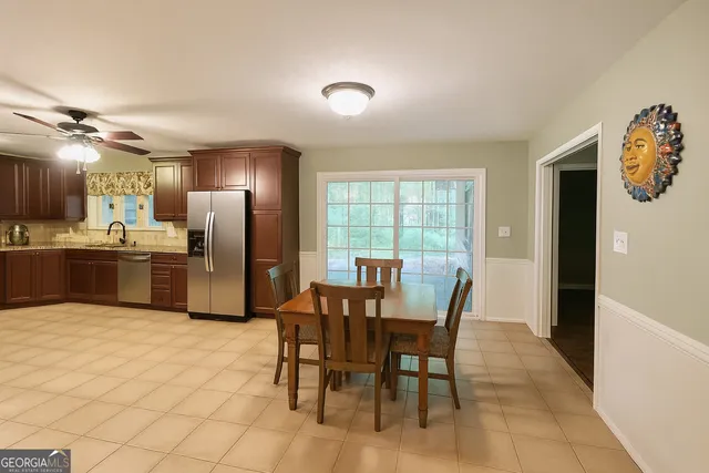a view of a dining room with furniture and a chandelier