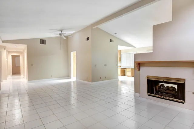 a view of an empty room with a fireplace