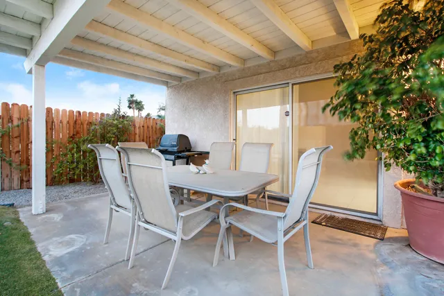 a view of a dining room with furniture and a potted plant