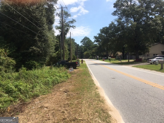 a view of swimming pool with a yard and trees