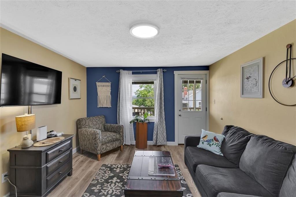 1646 Main Street Leechburg, PA 15656 - Photo 16 of 33 a living room with furniture a flat screen tv and a window