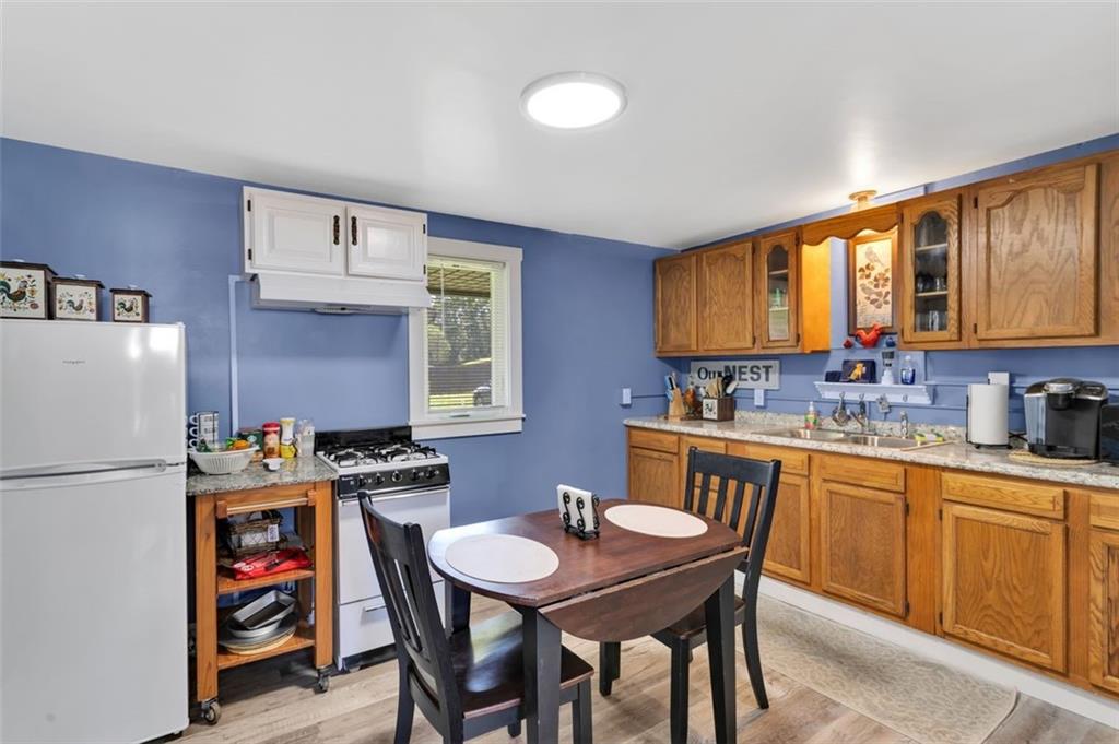 1646 Main Street Leechburg, PA 15656 - Photo 23 of 33 a kitchen with stainless steel appliances a stove a sink cabinets and a refrigerator