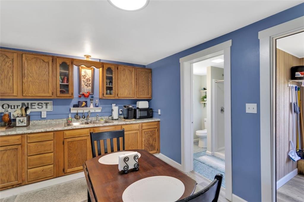 1646 Main Street Leechburg, PA 15656 - Photo 27 of 33 a kitchen with a table chairs sink and cabinets