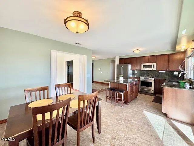 a view of a dining room with furniture and a rug