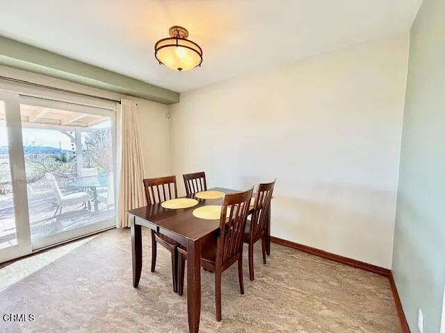 a view of a dining room with furniture and window