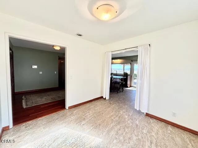 a view of a room with wooden floor