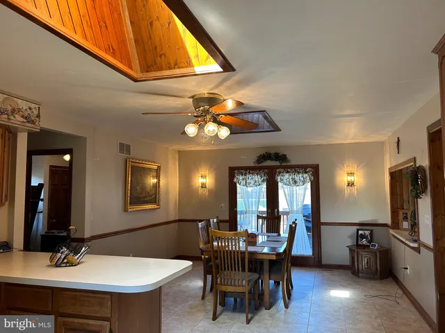 a view of a dining room with furniture and a chandelier