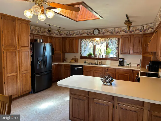 a kitchen with a refrigerator and a sink