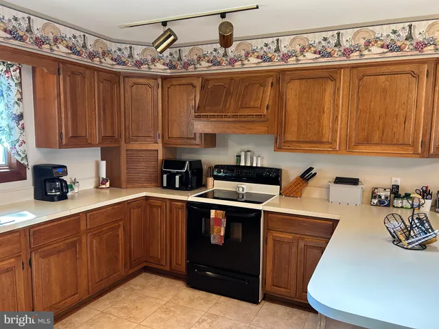 a kitchen with stainless steel appliances granite countertop a sink a stove and cabinets