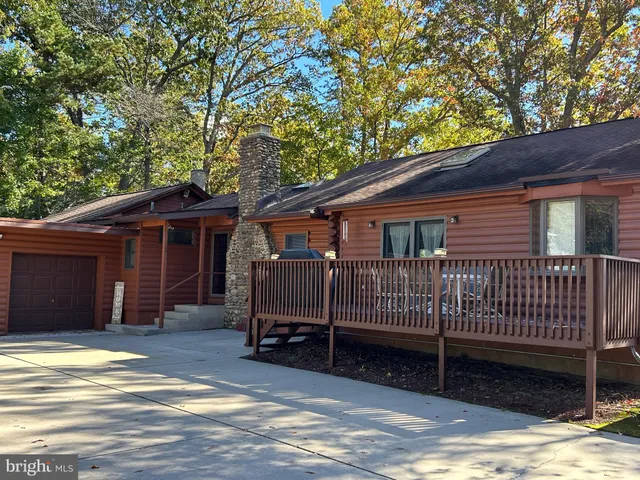 a view of a house with a balcony and wooden fence