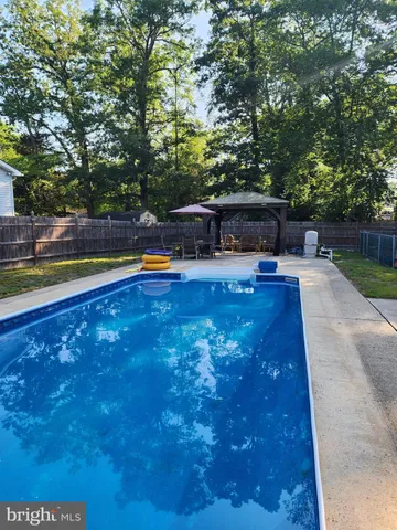 a swimming pool with outdoor seating and yard