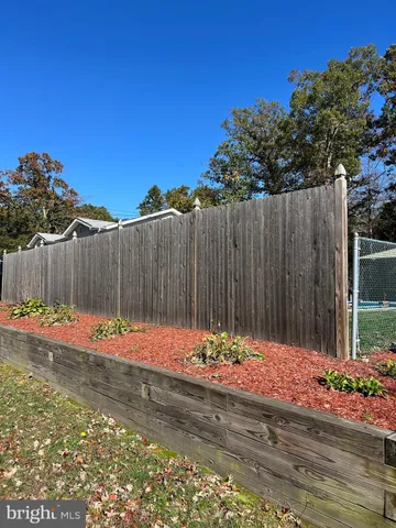 a view of a backyard with a wooden fence