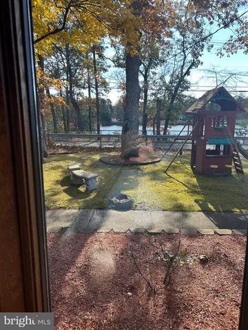 a view of yard with swimming pool and trees