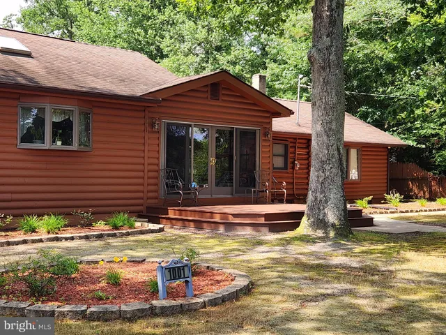 a view of a house with pool and sitting area