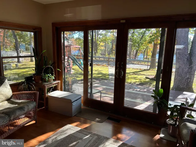 a living room with furniture floor to ceiling window and a floor to ceiling window
