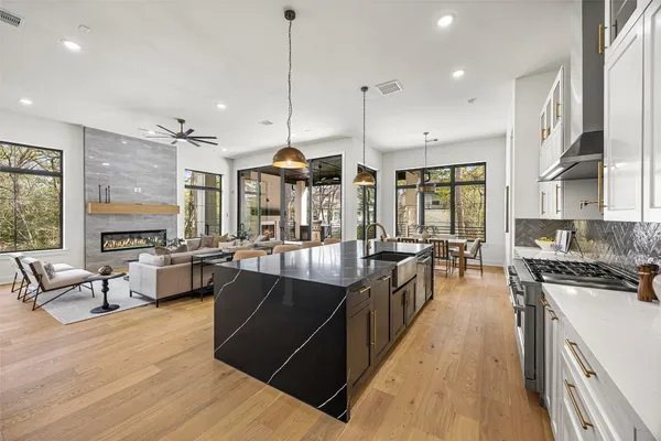 a living room with stainless steel appliances furniture and a open kitchen view