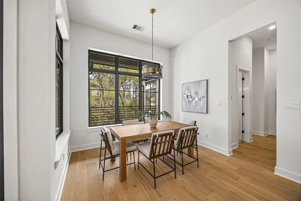 a kitchen with a refrigerator and a white wooden floor