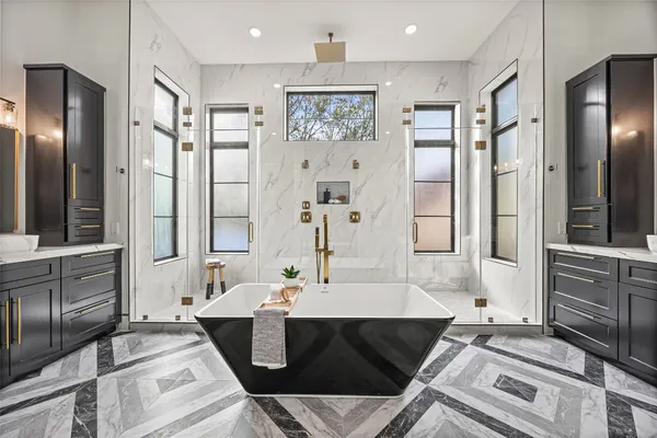 a bathroom with a double vanity sink mirror and shower