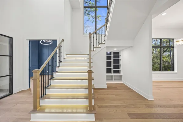 a view of entryway and hall with wooden floor