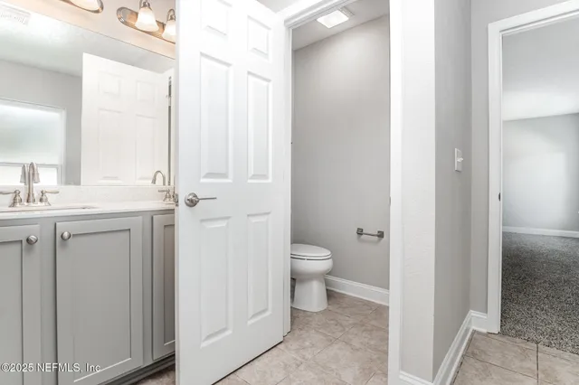 a bathroom with a toilet sink and a mirror