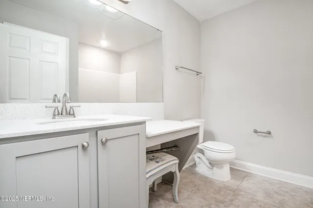 a bathroom with a sink toilet a mirror and vanity
