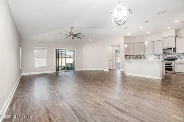 a view of a kitchen with a dishwasher cabinets and wooden floor
