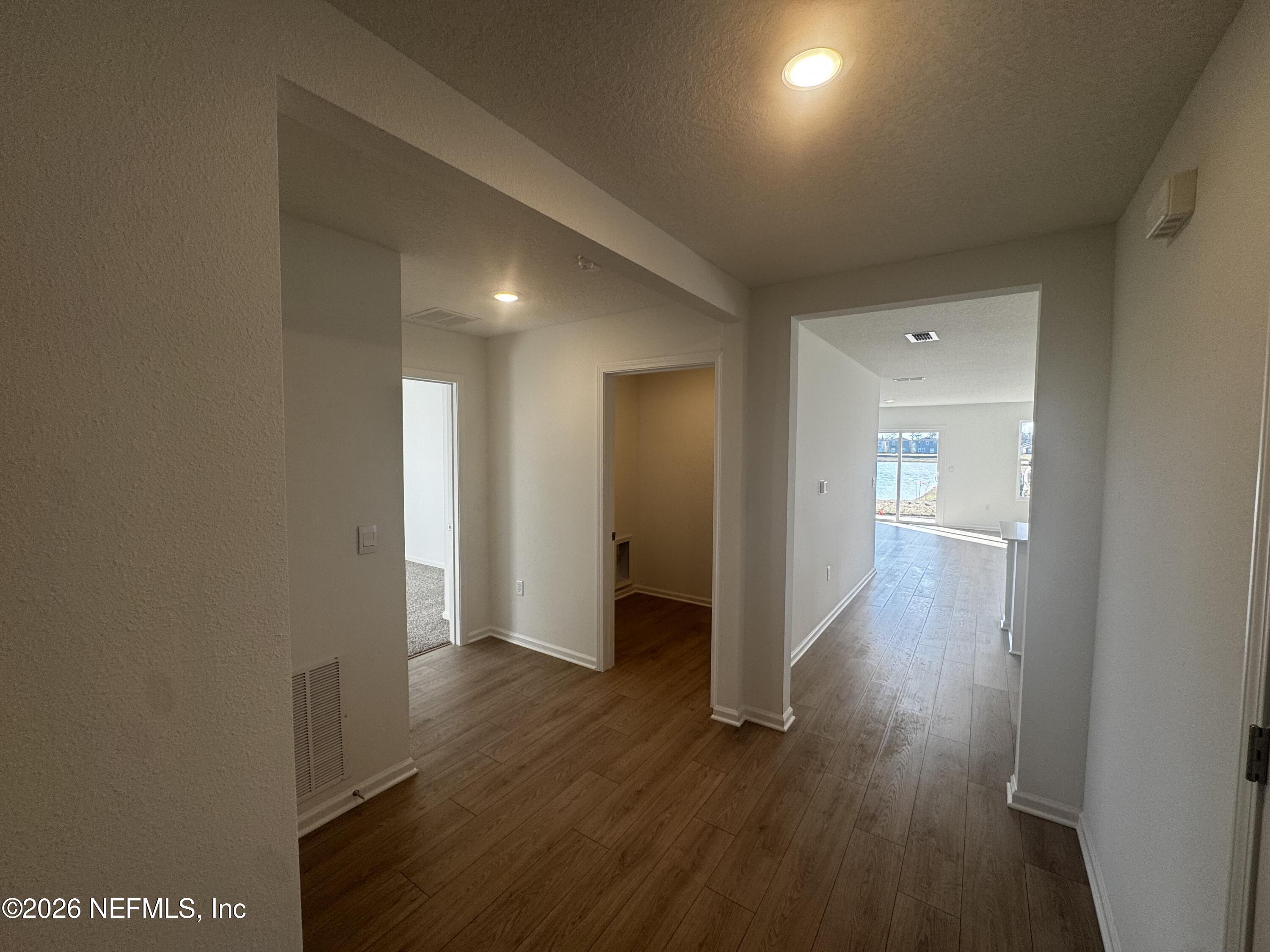 12390 Russian Olive Road Jacksonville, FL 32218 - Photo 25 of 67 a view of a hallway with wooden floor