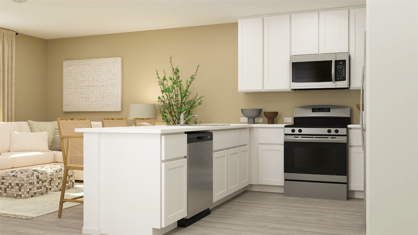 950 Pertuso Lane Huffman, TX 77336 - Photo 6 of 18 a kitchen with a sink and a stove top oven with wooden floor