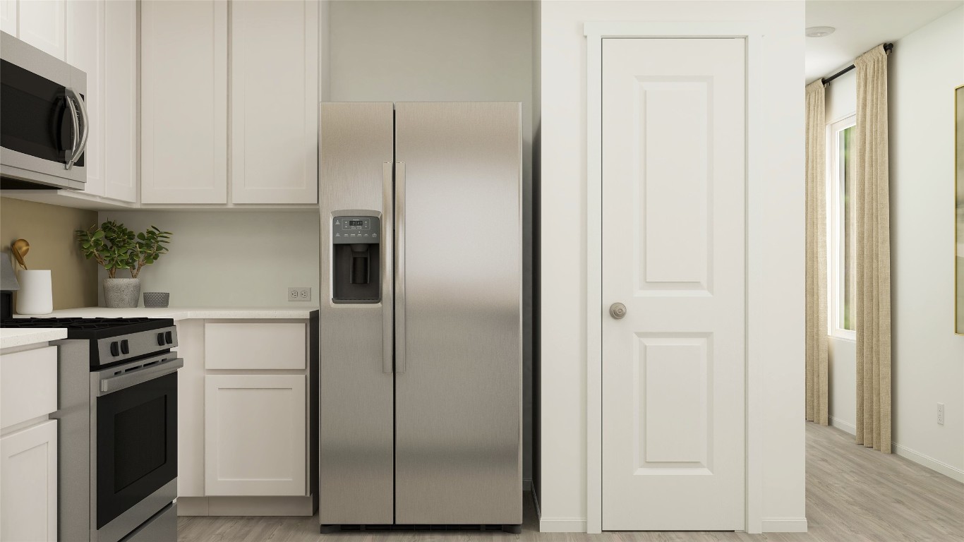 950 Pertuso Lane Huffman, TX 77336 - Photo 9 of 18 a kitchen with stainless steel appliances granite countertop a refrigerator and a stove top oven