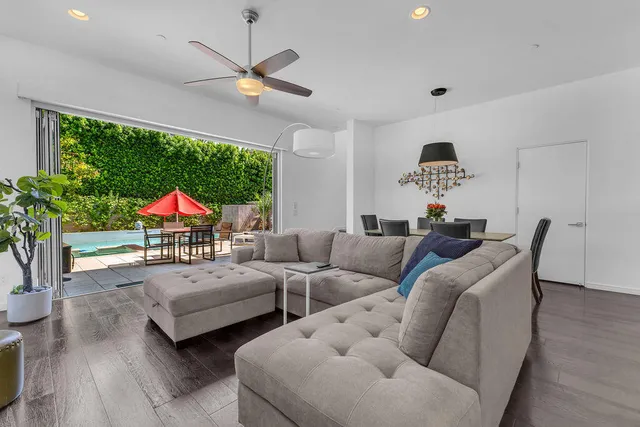 a kitchen with stainless steel appliances kitchen island granite countertop a table chairs and a refrigerator